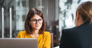 Two woman working on government budgeting on laptop