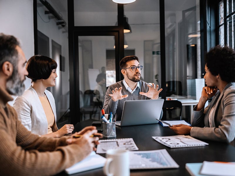 A multicultural team is working on start up project at the boardroom