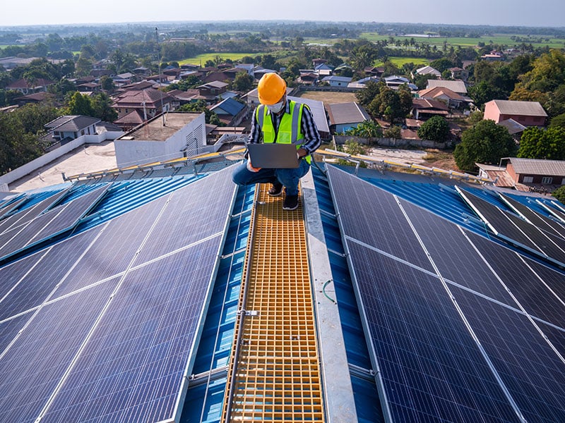 Technician checks the maintenance of the solar panels on the roof