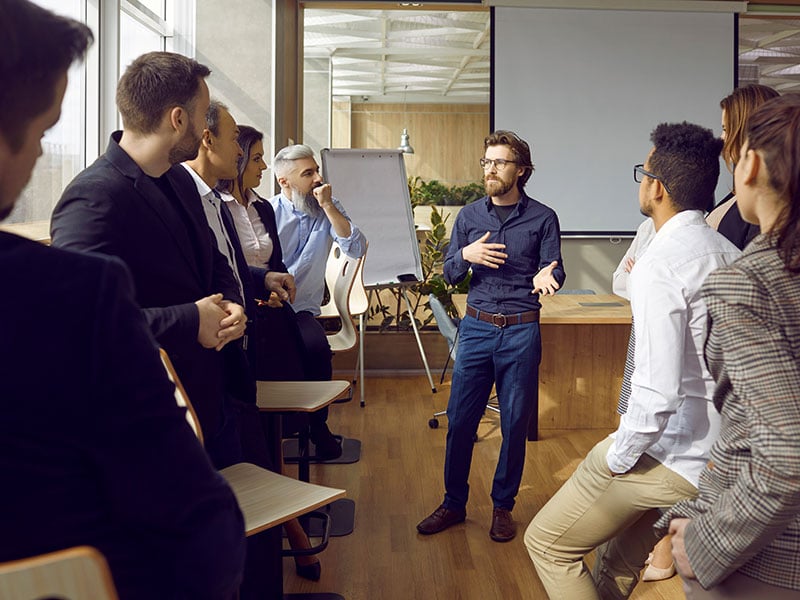 A group of workers listening to a presentation