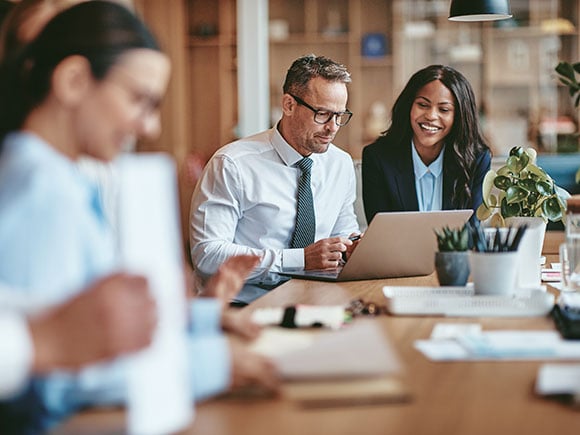 Businesspeople collaborating around a conference table