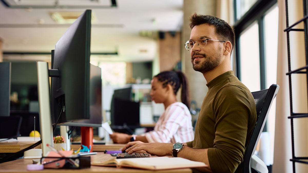 an employee working on computer in an open-plan office