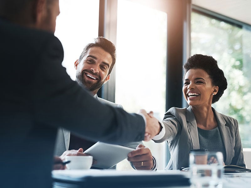 Handshake and meeting in teamwork for partnership or collaboration in boardroom