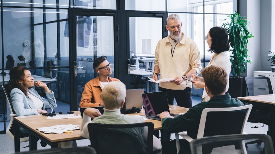 group of people collaborating around conference room table