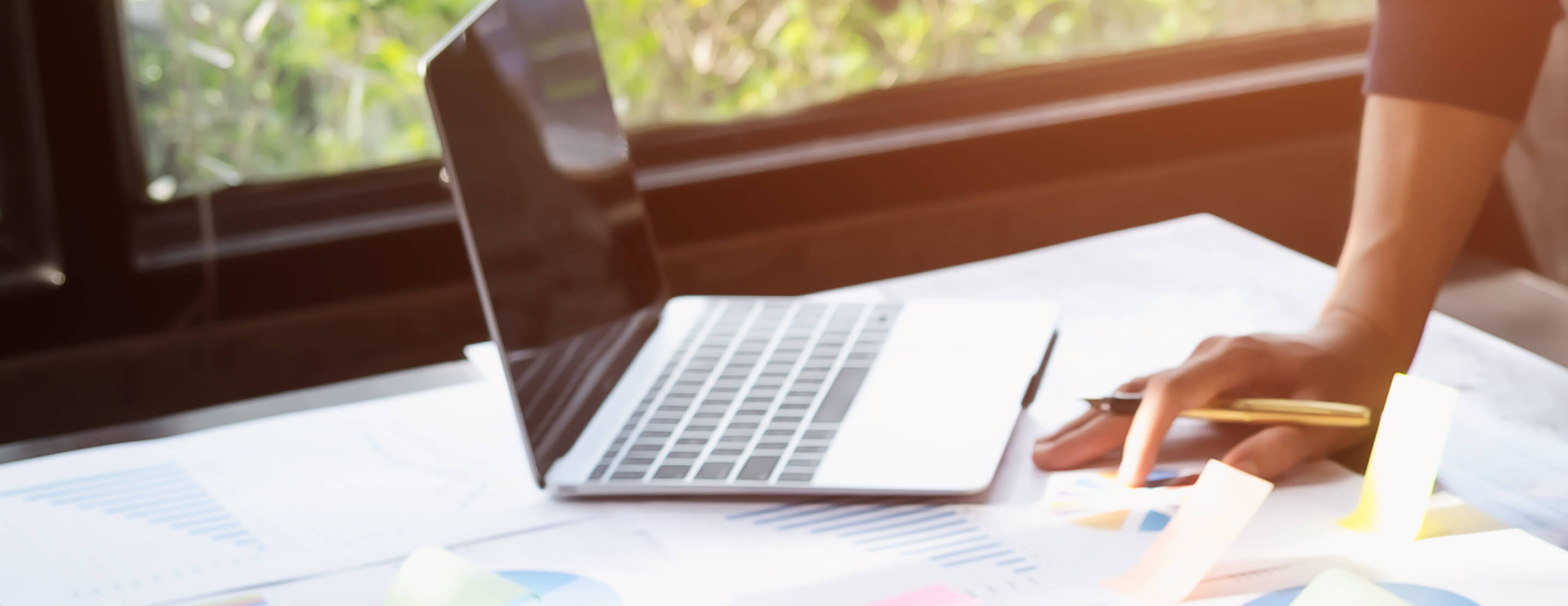 Government worker using graphs and laptop for budgeting